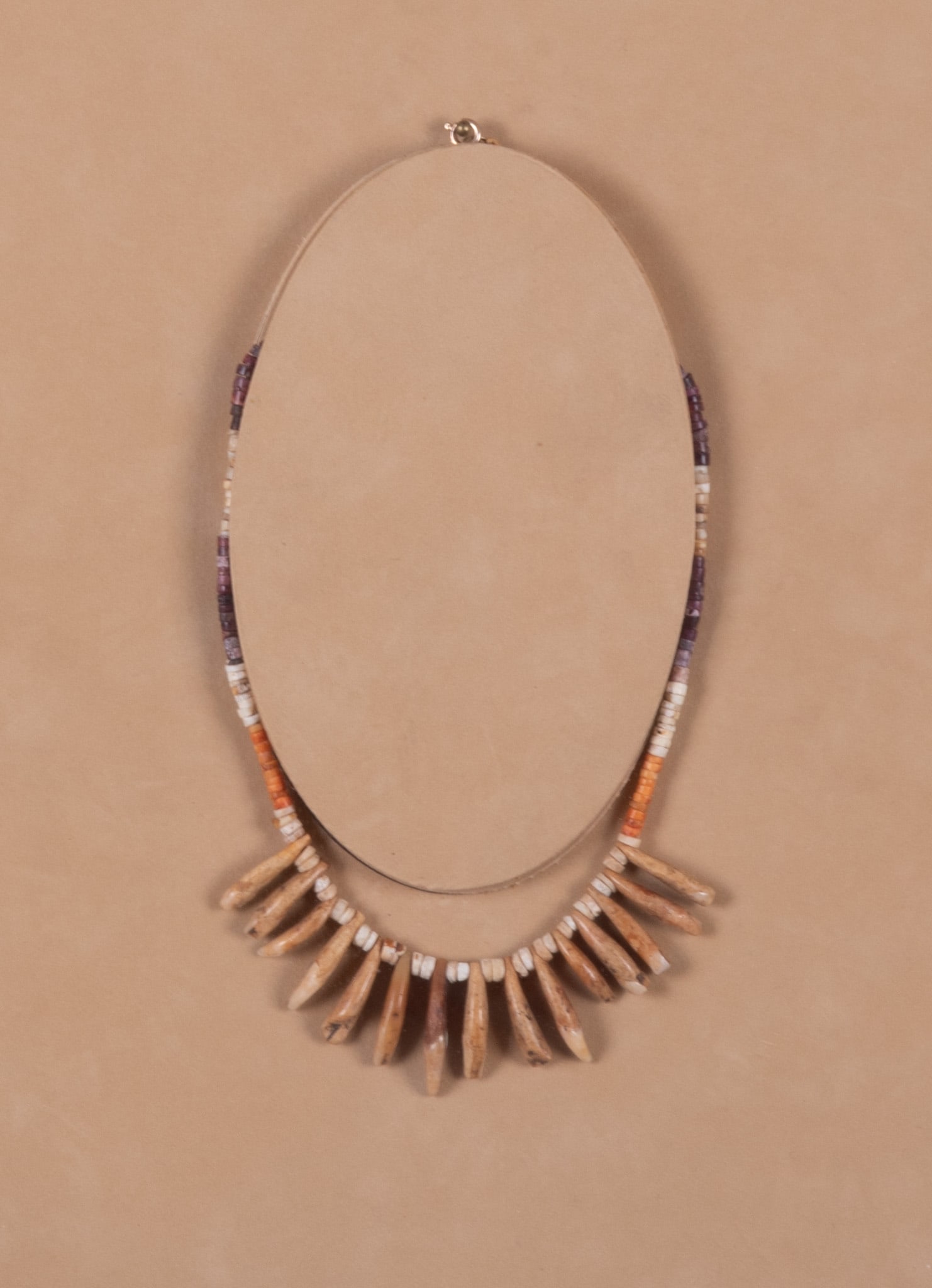 Columbian "Fang"Necklace Framed in a Shadowbox: The necklace consists of multi colored heishi beads and the "fangs" are possibly monkey teeth. The frame measures 17 x 11 3/4 x 1 1/4 inches. Paperwork available.