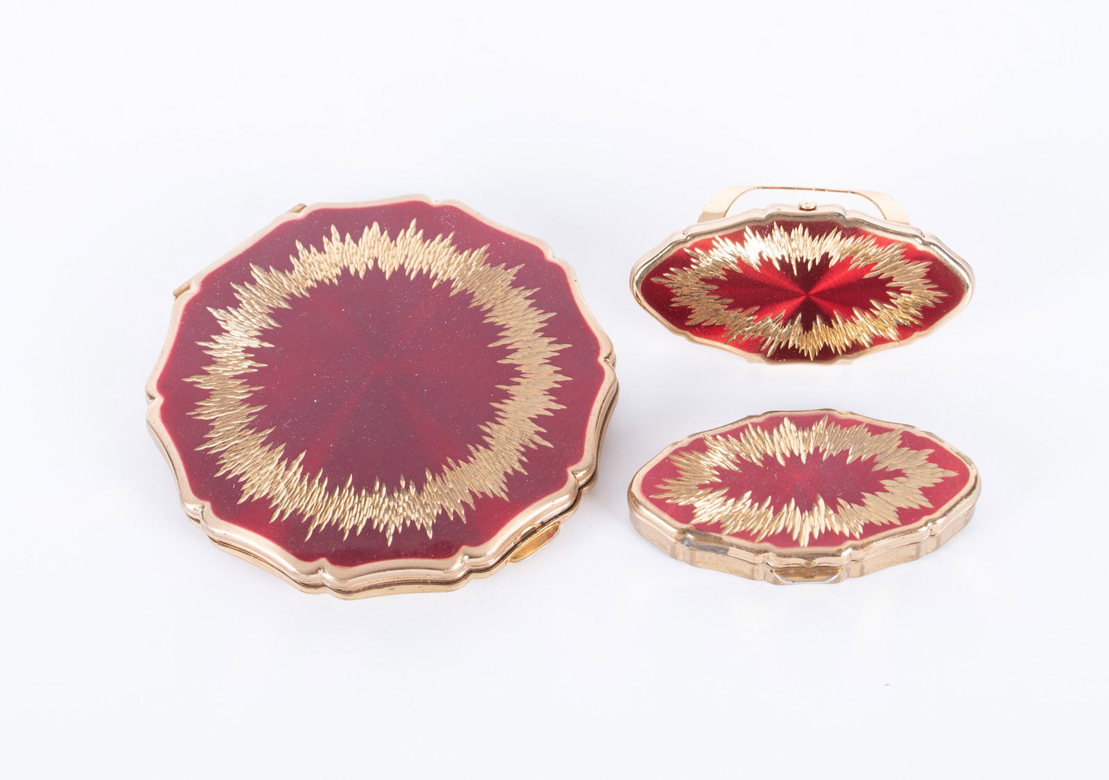 Collector's Vintage Stratton England Matched Vanity Accessories Include Compact, Lipstick Holder and: Stratton face powder mirrored compact in red and gold tone design, marked Made in England, diameter 3 5/8 inches, Pat. 764125; pill box marked, 2 1/2 inches; lipstick holder with malleable clip and