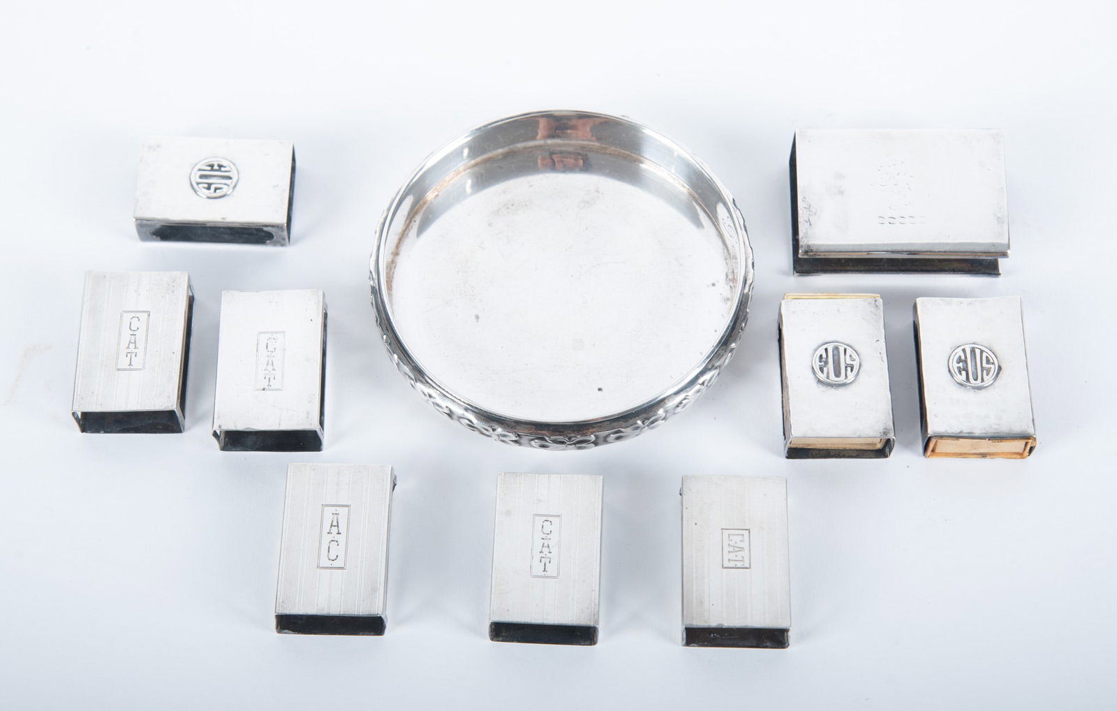 A Collection of Sterling Silver Table Articles: A sterling silver monogrammed wine coaster and 9 sterling silver match book holders, all vintage. 6.88 total troy ounces