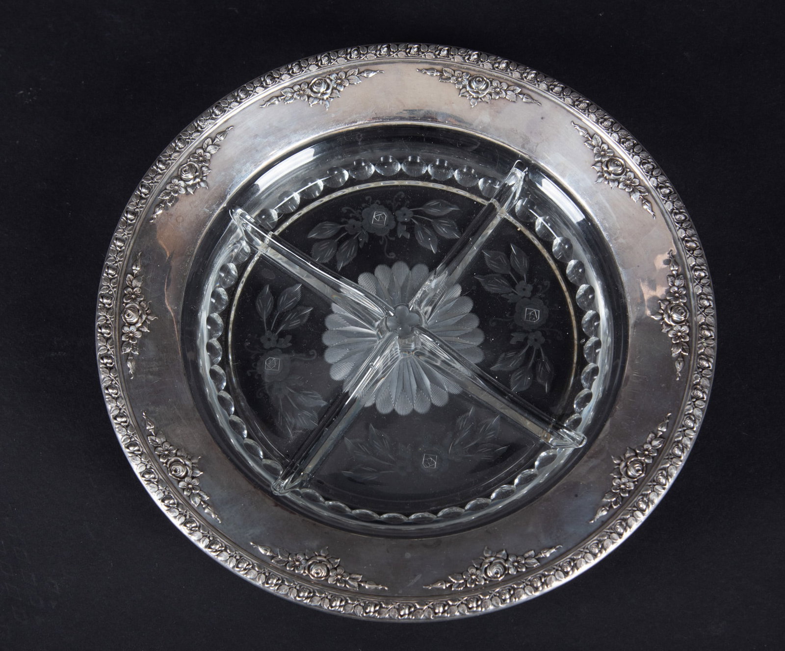A Sterling Silver Rimmed Etched Crystal Serving Dish: A substantial divided 4-section floral etched and beveled crystal dish, mounted with a sterling silver rim having a lavish floral border.