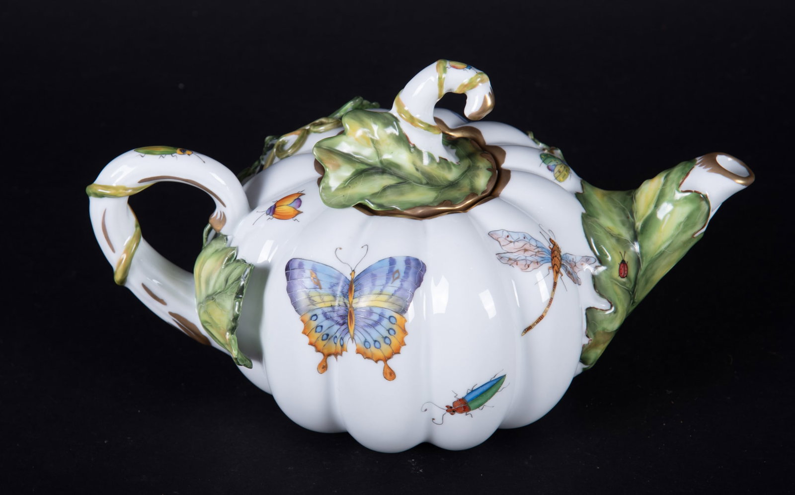 An Anna Weatherley Porcelain Pumpkin-Shape Teapot: Hungary, an unusual lobed teapot with applied vines by Anna Weatherly Deigns. In addition to the vines, the teapot is decorated with butterflies and insects.