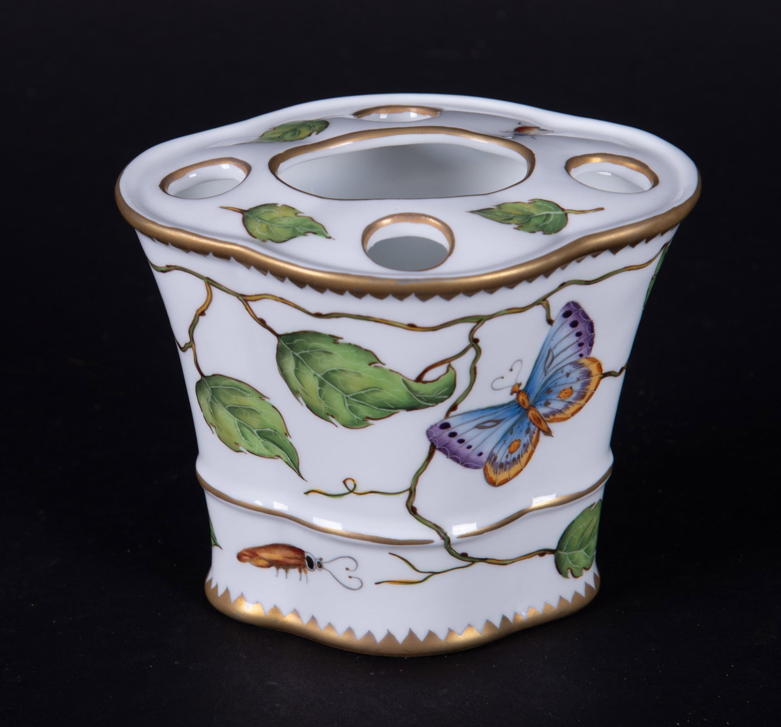 An Anna Weatherley Self-Arranging Porcelain Vase: Hungary, in the Ivy pattern by Anna Weatherley Designs, a 5-hole self arranging flower vase with ivy vines highlighted with a butterfly, dragonfly and other insects.