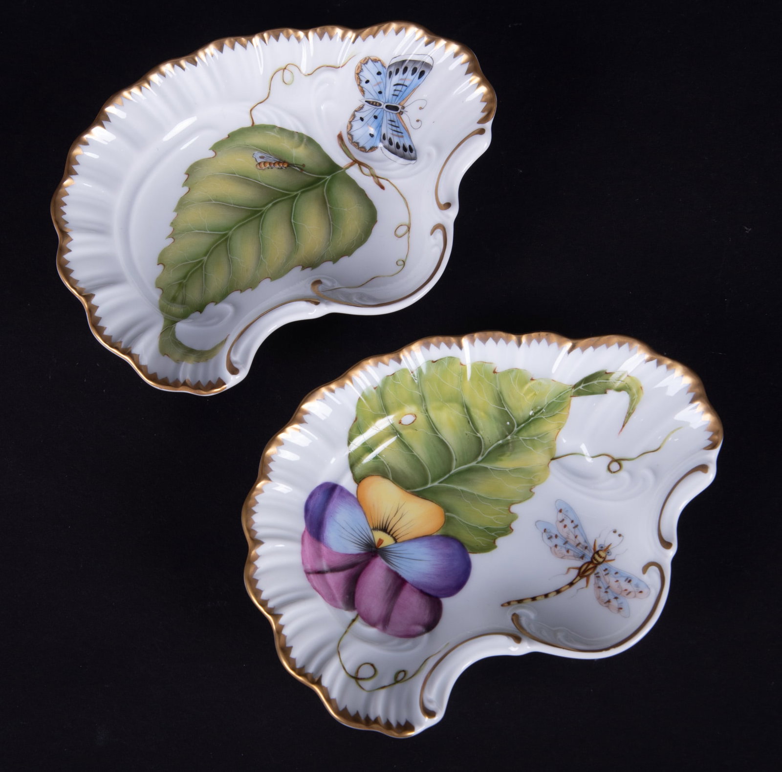 Two Anna Weatherly Porcelain Serving Dishes: Hungary, a pair of diminutive shaped dishes, one of the trays having a pansy pattern with a large dragonfly, the other featuring a large butterfly and ivy or grape leaf pattern. Both by Anna Weatherle