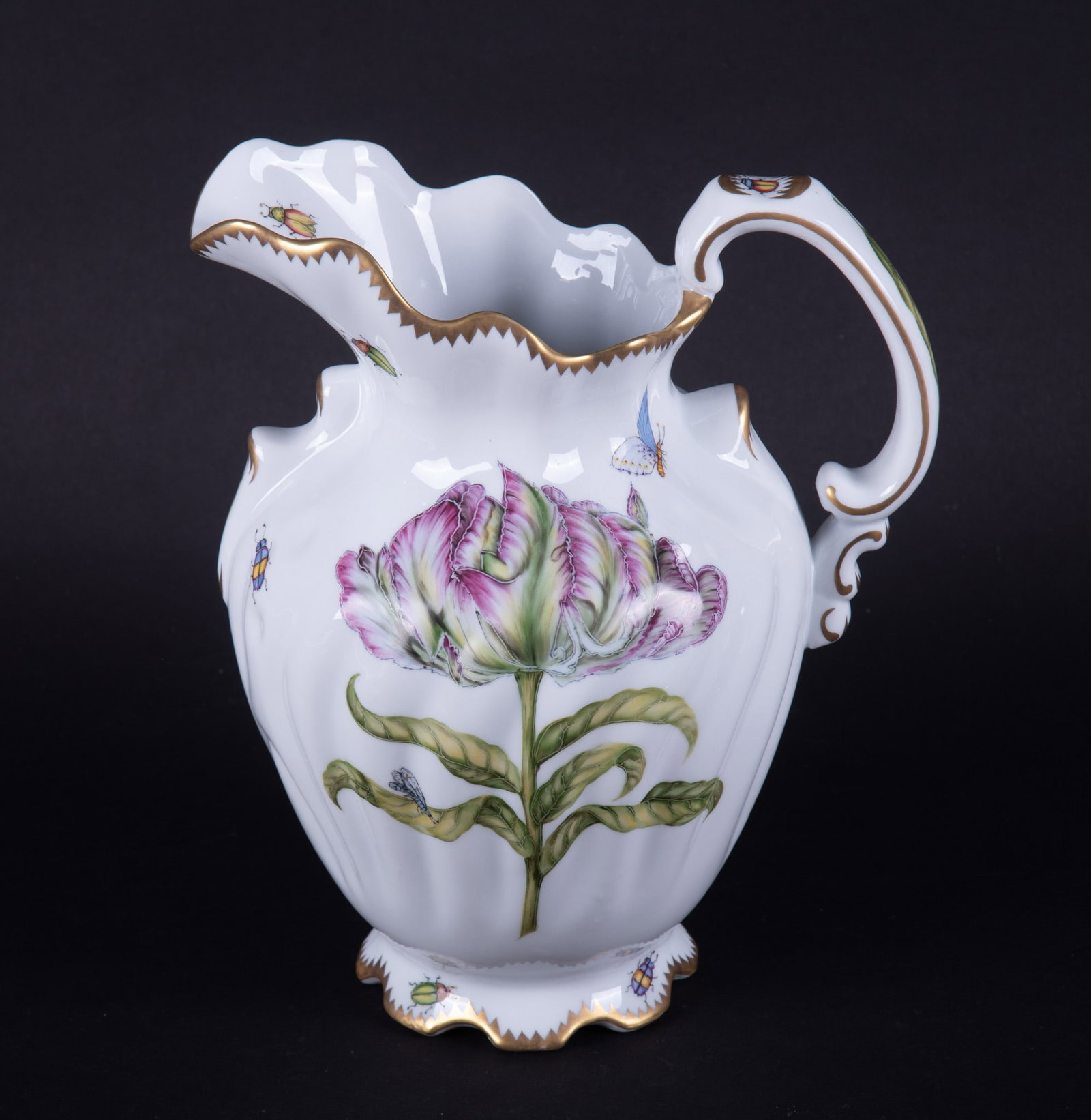 A Large Anna Weatherley Porcelain Pitcher, Old Master Tulips Pattern: Hungary, a fine hand painted porcelain pitcher by Anna Weatherley designs, painted with a large tulip bloom, the base featuring beetles, the body decorated with butterflies and insects.