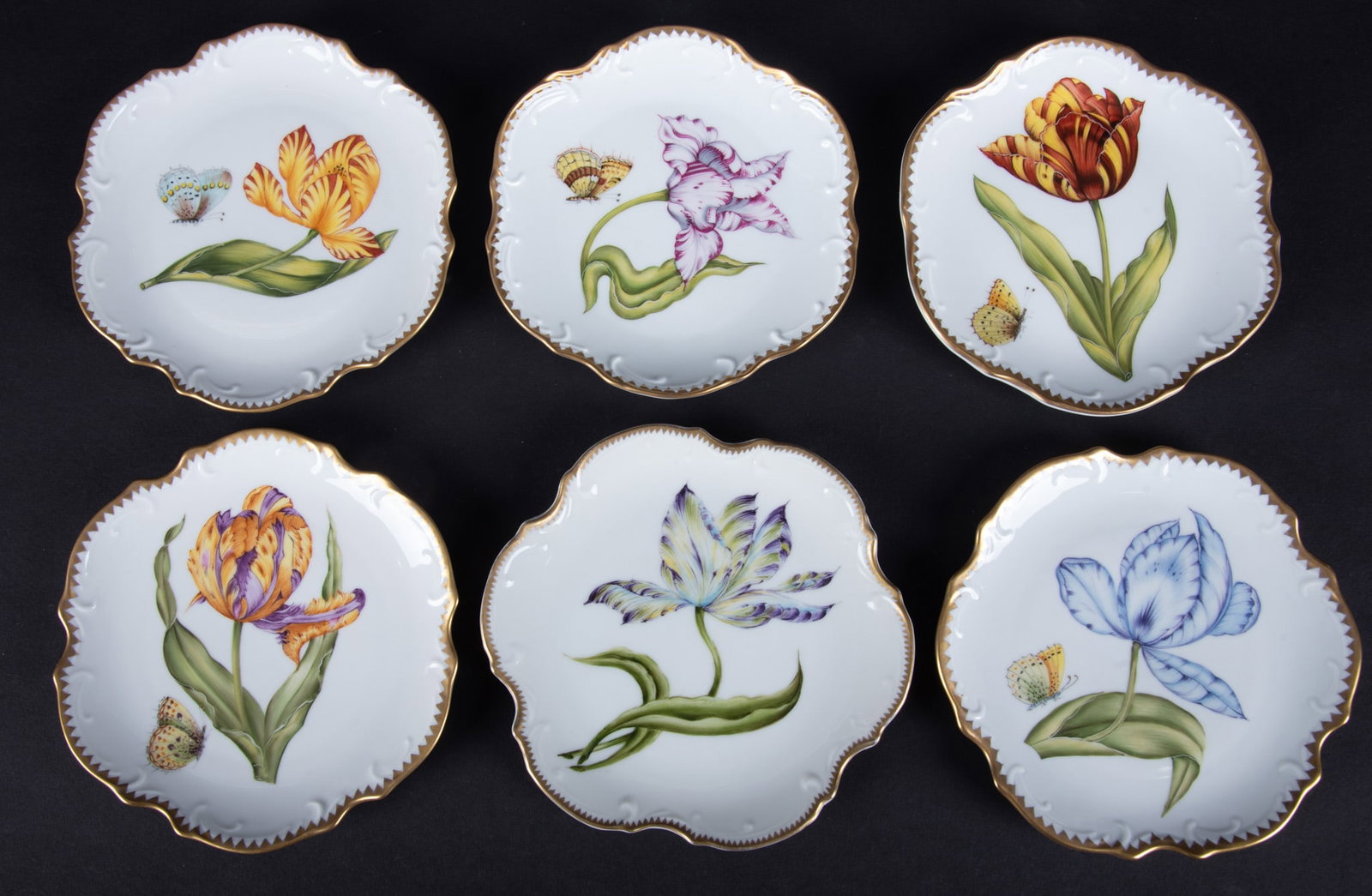 Six Anna Weatherley Tulip Bread and Butter Plates: Hungary, from the Old Master Tulip collection, a rare to find set of 6 hand painted plates by Anna Weatherley design. Each of the scalloped edge bread and butter plates featuring a beautiful tulip and