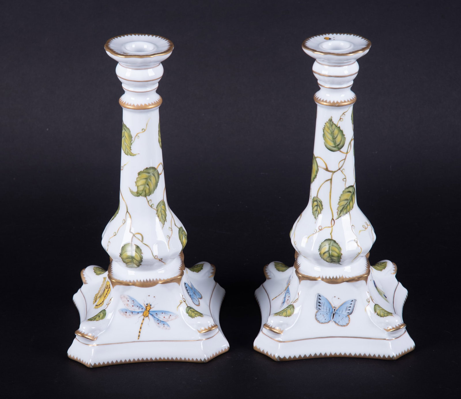 A Pair of Anna Weatherly Hand Painted Porcelain Candlesticks: Hungary, by Anna Weatherley designs, a difficult to find pair of 10 1/4 inch candlesticks in the Ivy Garden pattern, the sides of the base painted with butterflies and insects, the stems painted with 
