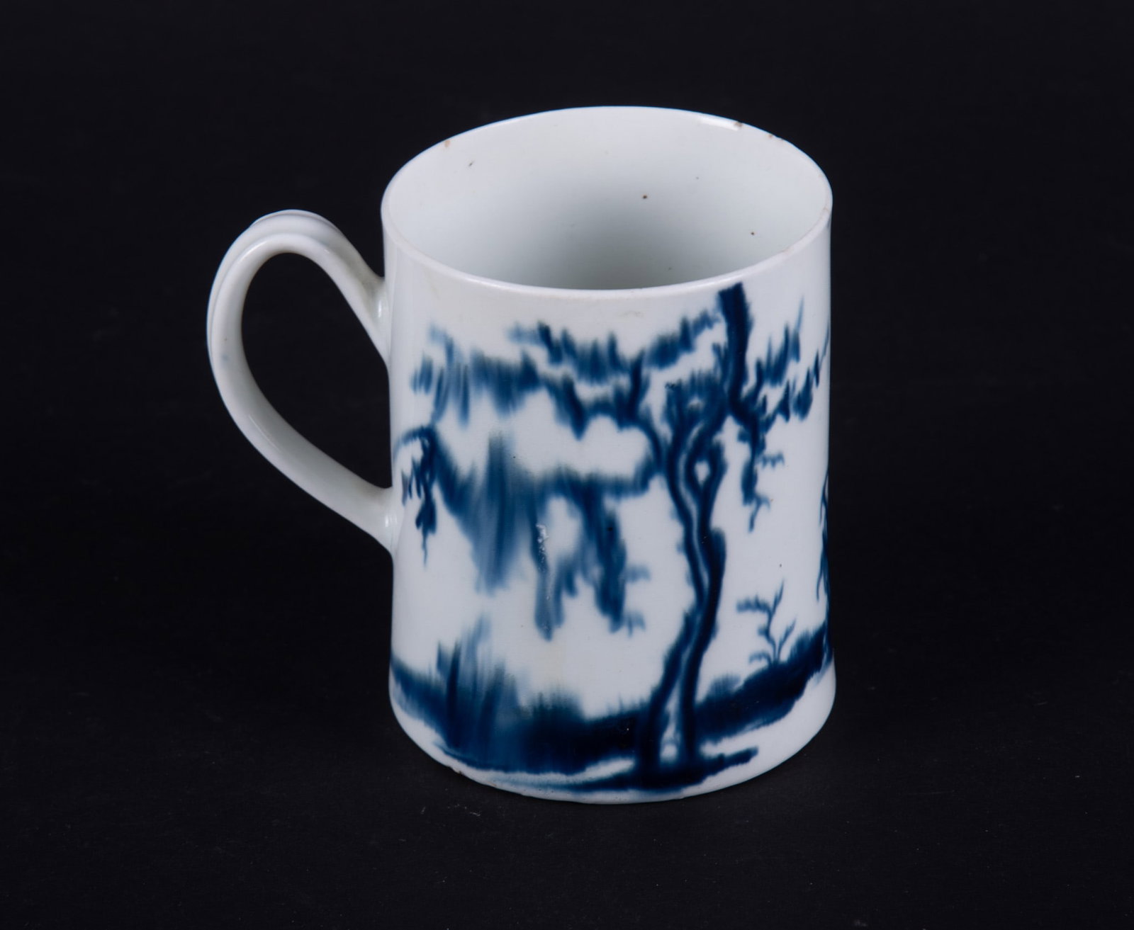A Rare 18th Century Worcester Handled Mug, The Walk in the Garden: England, circa 1760, Dr. Wall first period, in the Chinoiserie style, the straight-side mug features a scene of an Asian maiden encountering a young man holding a shaft, a bird about to perch on a nea
