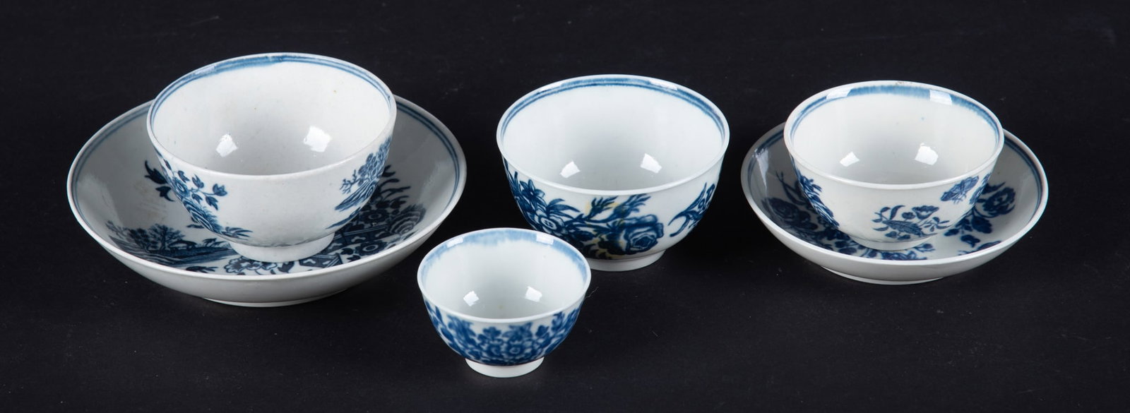 A Collection of 18th Century Worcester Cups and Saucers, Dr. Wall Period: England, circa 1780, a good grouping of early Worcester porcelains to include a rare Broken Fence cup and saucer featuring a Chinoiserie design (Saucer 5 inch diameter, Cup 1 3/4 inches tall), a Three