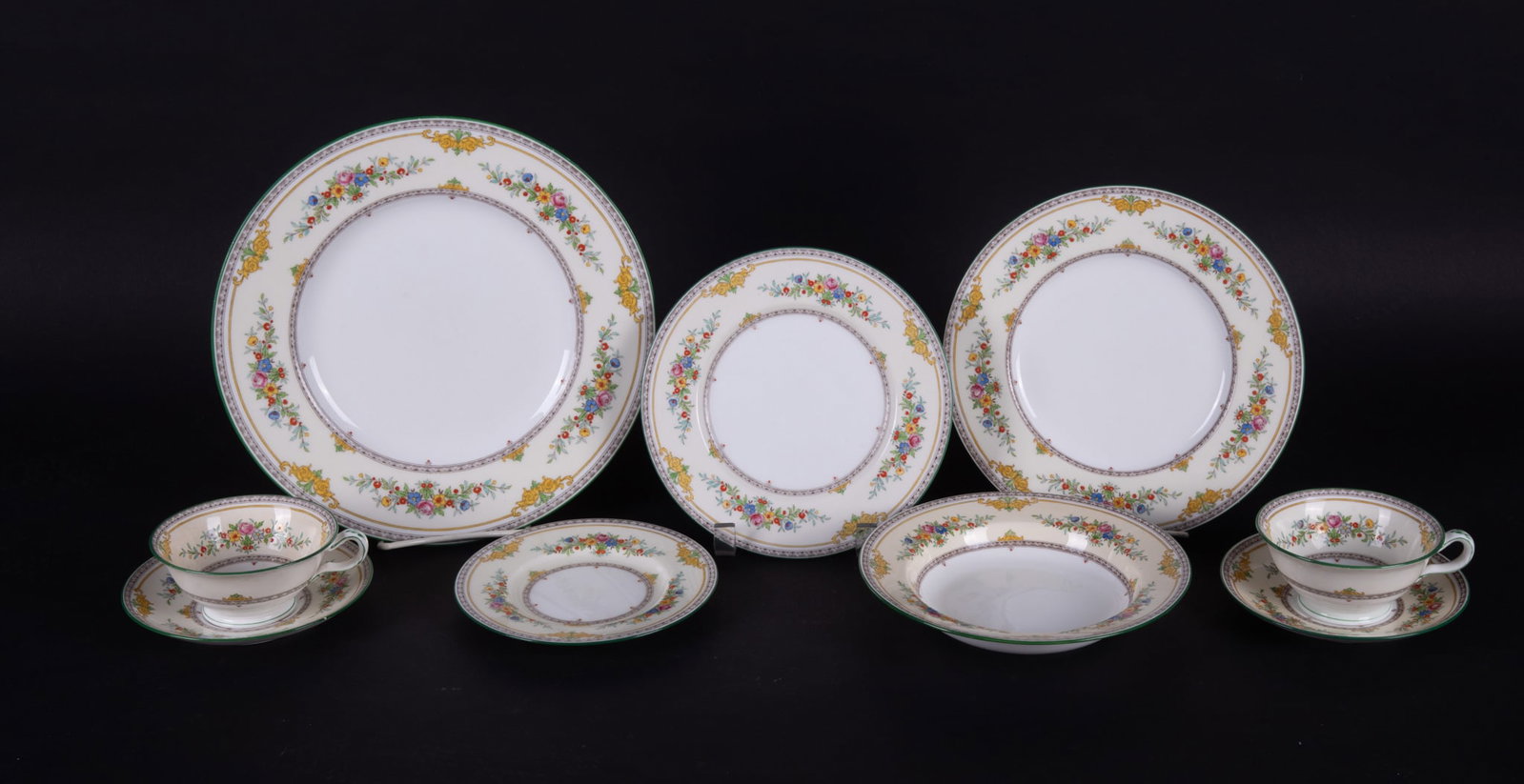 A Fine and Extensive Minton Porcelain Dinner Service for Twelve, Stanwood Pattern: England, circa 1928, green rim Stanwood pattern having floral sprays amongst the cream border. The set consists of Twelve 10 5/8 inch Dinner Plates, Twelve 8 3/4 inch Luncheon Plates, Twelve 7 1/2 inc