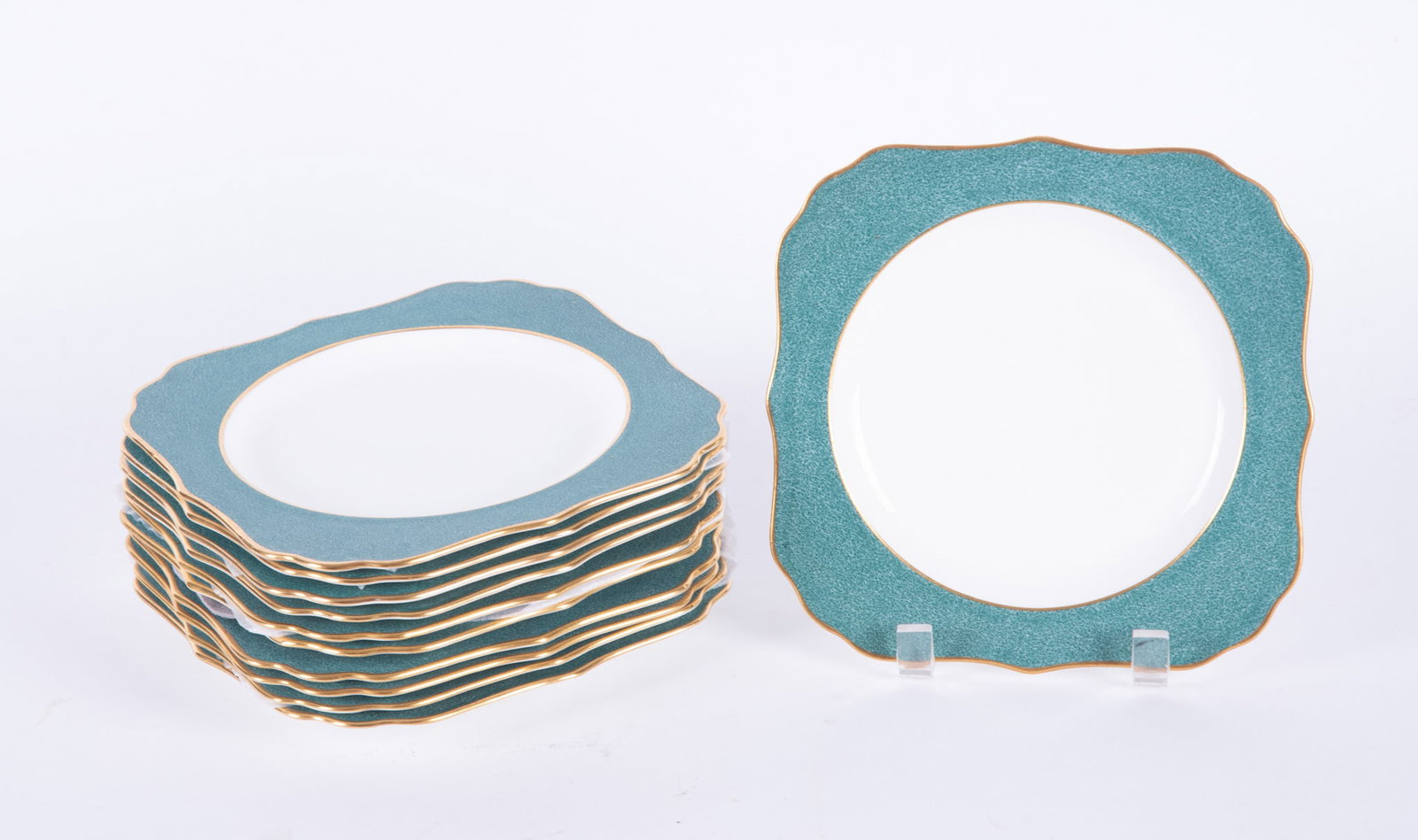 Eleven Royal Doulton Art Deco Porcelain Plates: England, 11 sqaure-form plates with gilt shaped edges on cream grounds, marked Royal Doulton made in England BB 1827, H 2508.
