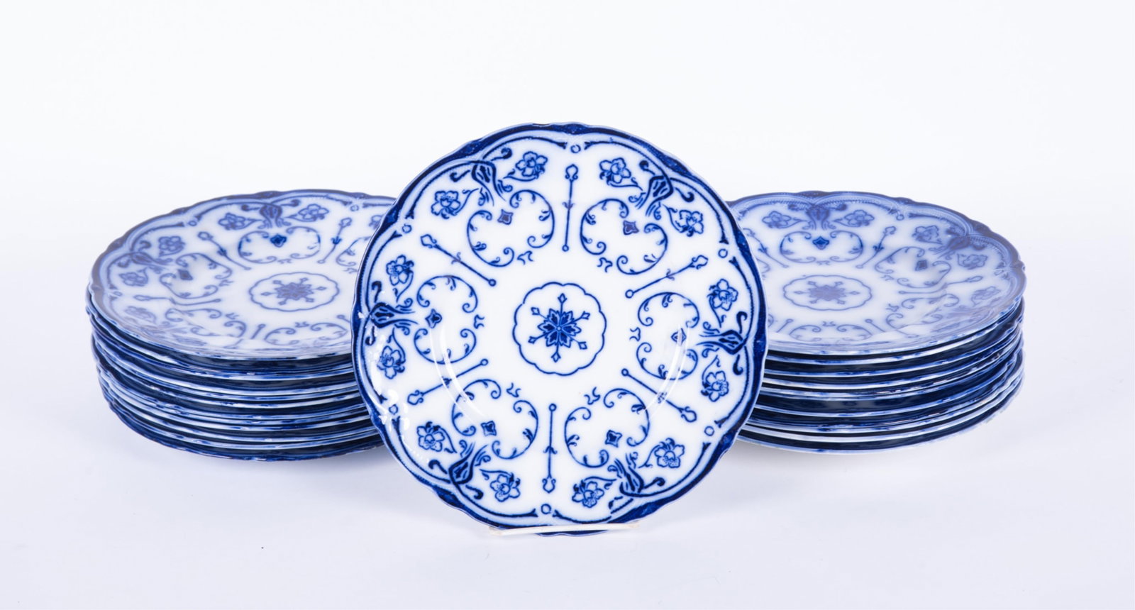 A Collection of Twenty-Four Flow Blue Staffordshire Dinner Plates, Conway by New Warf Pottery: Burslem, England, circa 1890, a rarely found set of 24 dinner plates (10 inch) in the Conway pattern. Produced roughly from 1878-1894, the pattern features a stylized floral and geometric design that 