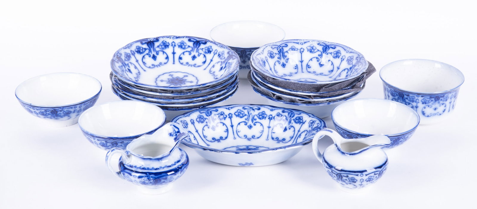 A Large Collection of Flow Blue Staffordshire Serving Bowls and Pieces, Conway by New Warf Pottery: Burslem, England, circa 1890, a very nice collection of bowls and creamers in the Conway pattern, the collection includes 2 rare deep bowls (3 1/8 x 5 3/4, some wear on both); an oval vegetable bowl (