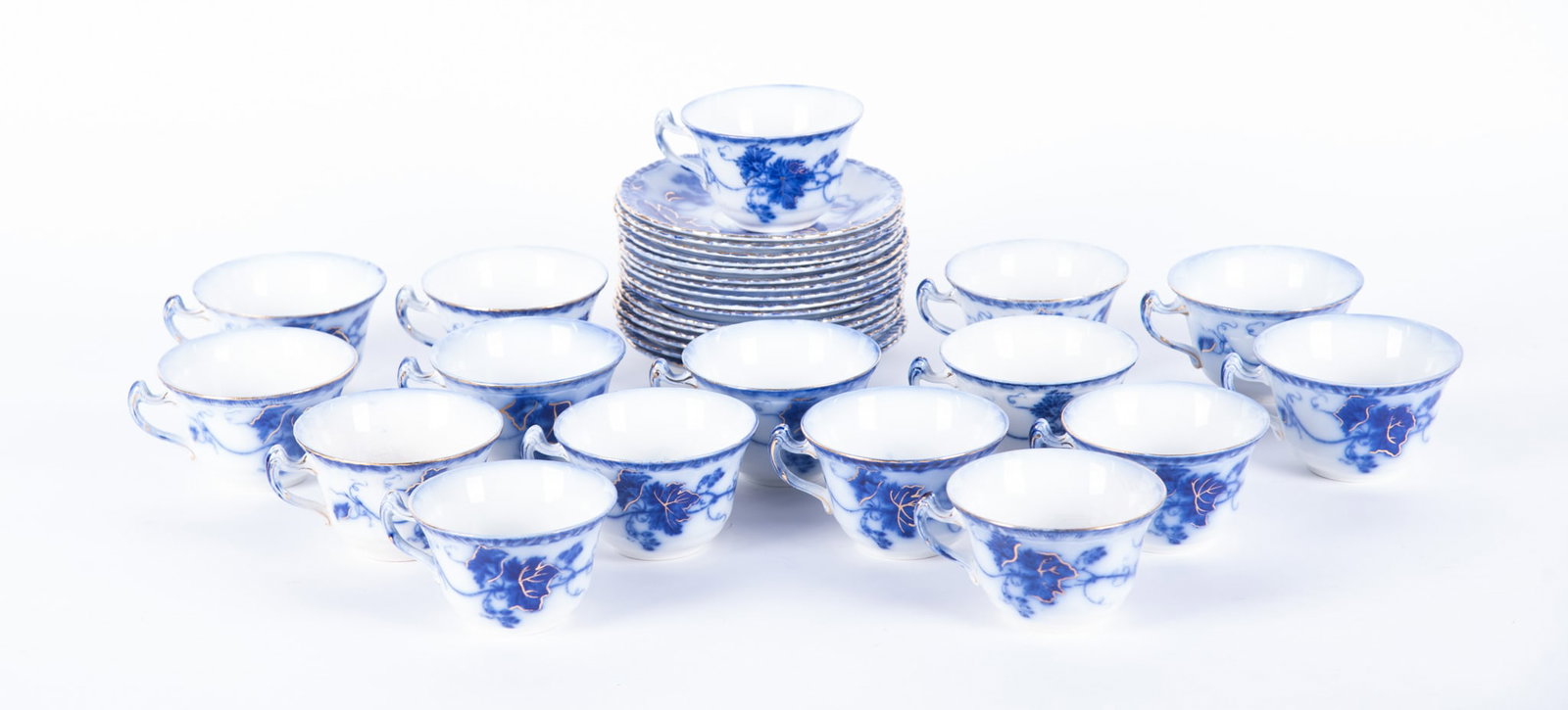 A Rare Set of Sixteen Staffordshire Flow Blue Cups and Saucers, Virginia by John Maddock and Sons: England, circa 1890, a desirable set of 16 flow blue cups and saucers by John Maddock in the Virginia pattern, the scalloped edge saucers supporting a finely shaped handled cup, both pieces having a g