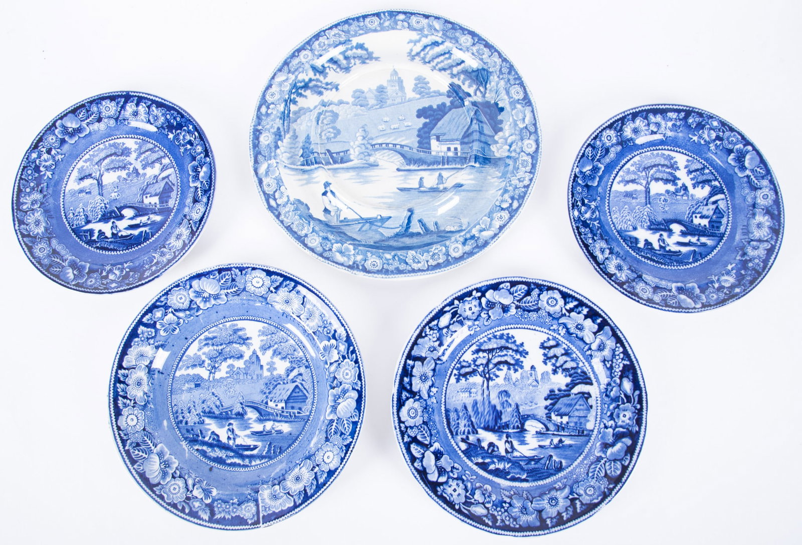 A Grouping of Antique English Blue Transferware, Wild Rose Pattern: England, mid-19th century, all pieces by various makers, in the Wild Rose pattern featuring a rural village scene in Nuneham Courtenay. The collection includes 4 plates (one plate bearing mark for