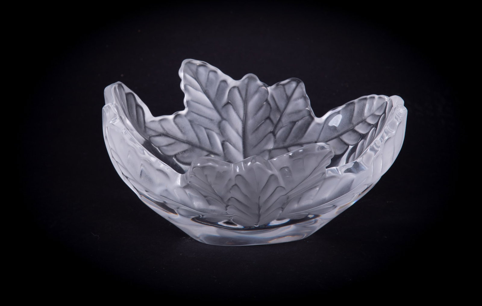 A Lalique Crystal Compiegne Bowl: France, a clear and frosted glass bowl having a large oak leaf pattern. Marked Lalique France and signed to base by Marie Claude Lalique 1995.