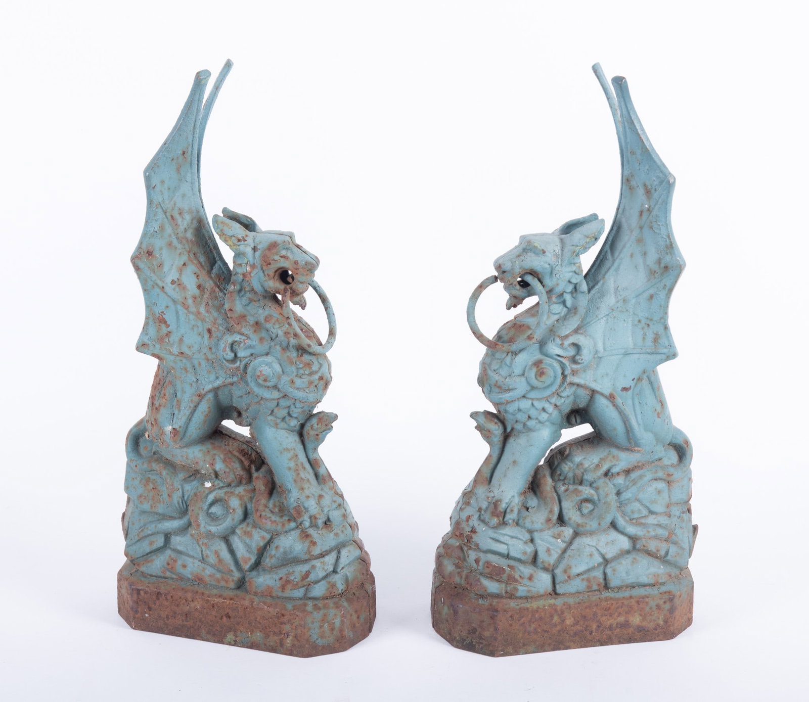 A Pair of Antique Cast Iron Griffin Post Finials: A Pair of Antique Cast Iron Griffin Post Finials An interesting pair of cast Griffin or Gargoyle sculptures, likely meant for a gate or post cap. With remnants of green paint. 5 x 8 x 18 1/4 inches
