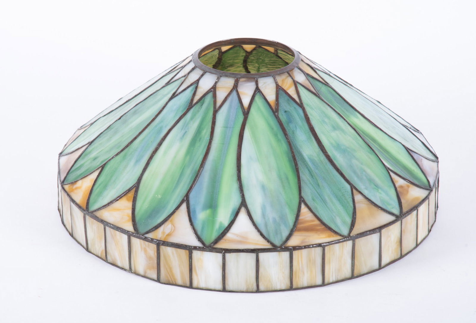 An Antique Slag and Leaded Glass Lamp Shade: An Antique Slag and Leaded Glass Lamp Shade American, attributed to JA Whaley & Co, a spear type shade with caramel glass and large green slag glass leaves. 16 inch diameter, 6 3/8 inches tall, 4