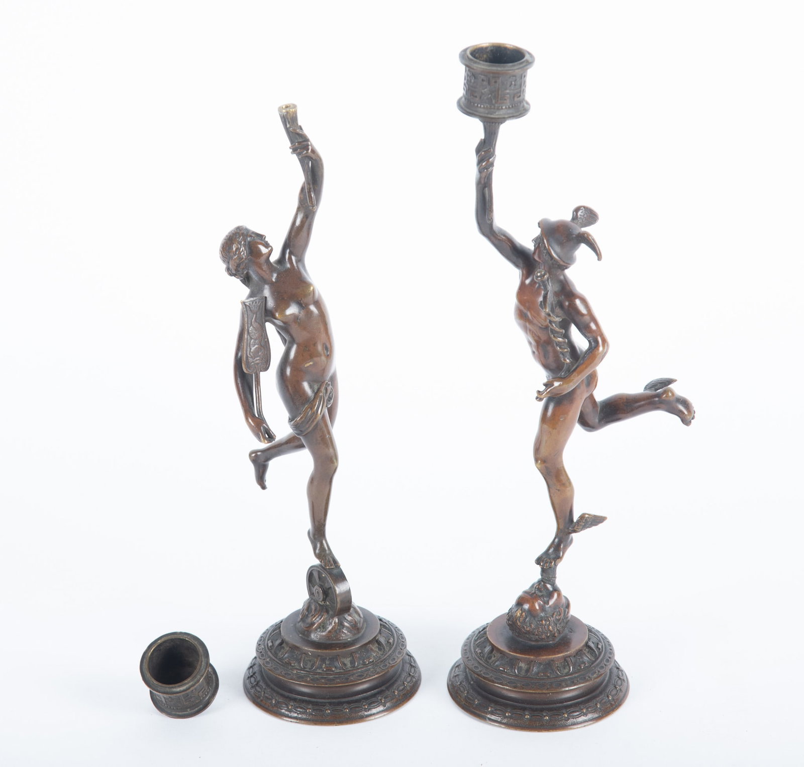 A Pair of Grand Tour Bronze Candlesticks, Hermes and Fortuna: A Pair of Grand Tour Bronze Candlesticks, Hermes and Fortuna Two finely cast bronze figures, one of Hermes, perched atop a column of air emerging from the mouth of Zephyr, holding a caduceus. The