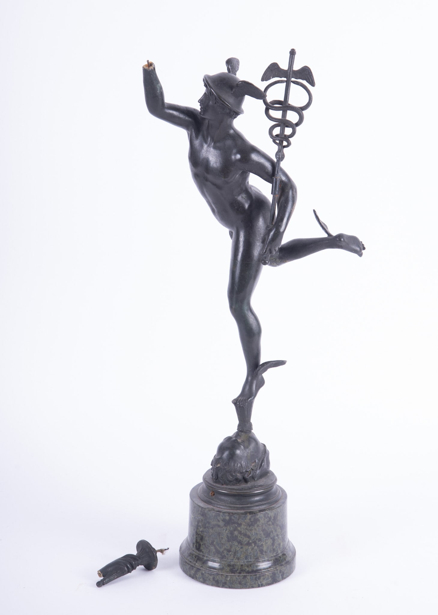 A Grand Tour Bronze of Hermes: A Grand Tour Bronze of Hermes After the antique by Giambologna, the bronze of Hermes (Mercury) gracefully stands atop a column of air emerging from the mouth of Zephyr, in his left arm the figure is