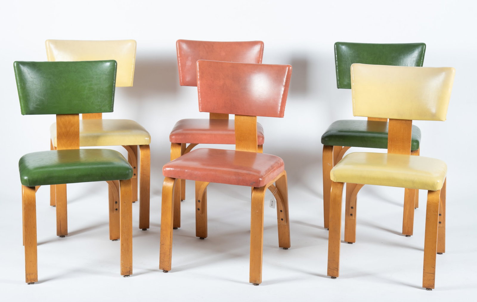 Set of Six Mid-Century Modern Bent Plywood Thonet Chairs: Set of Six Mid-Century Modern Bent Plywood Thonet Chairs Six molded plywood chairs by Thonet New York, two green upholstered, two yellow upholstered and two orange upholstered 32 x 17 1/2 x 19 inches