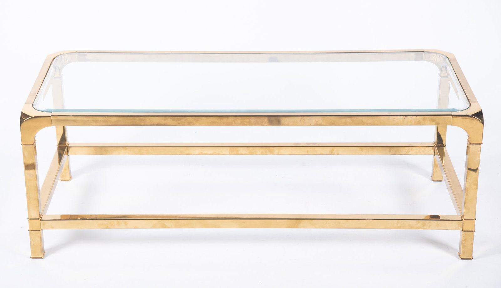 Mastercraft Mid-Century Brass And Glass Coffee Table: Mastercraft Mid-Century Brass And Glass Coffee Table Beveled glass top on a gilt metal frame with rounded corners. 17 x 48 x 20 nches