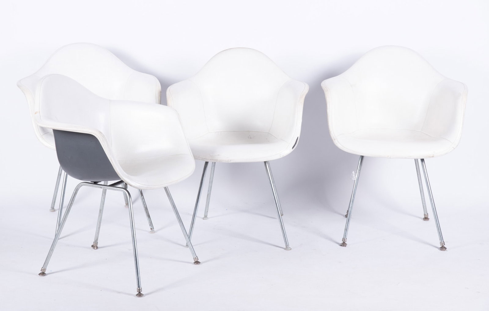 Set of Four Eames for Herman Miller Molded Plastic Upholstered Armchairs: Set of Four Eames for Herman Miller Molded Plastic Upholstered Armchairs White vinyl upholstery and 4-leg base, circa 1980s 31 x 24 1/2 x 23 1/2 inches