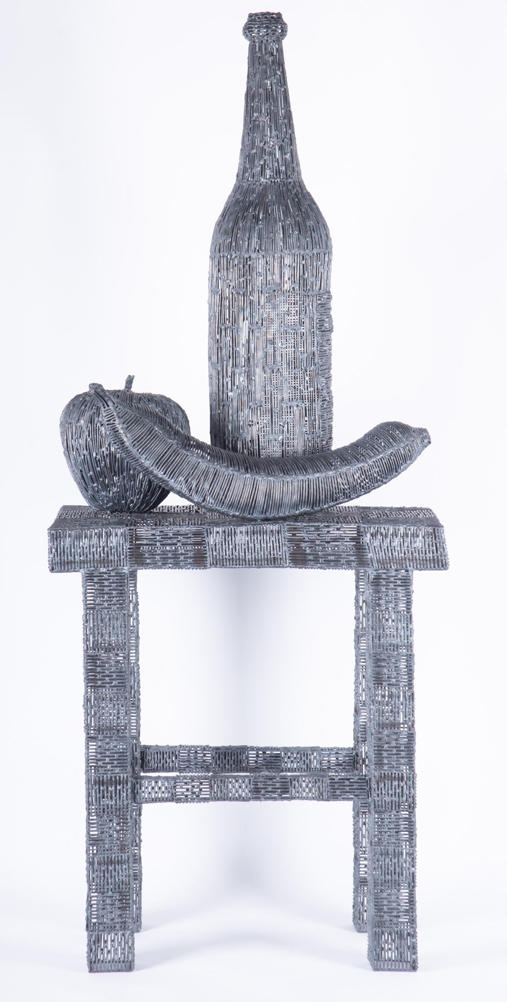 Kent Addison, Missouri (1937-2020), Still Life with Fruit and Bottle on a Stool, metal wire: Kent Addison Missouri, (1937-2020) Still Life with Fruit and Bottle on a Stool metal wire sculpture unsigned. Provenance: The estate of the artist. 48 x 20 x 11 inches