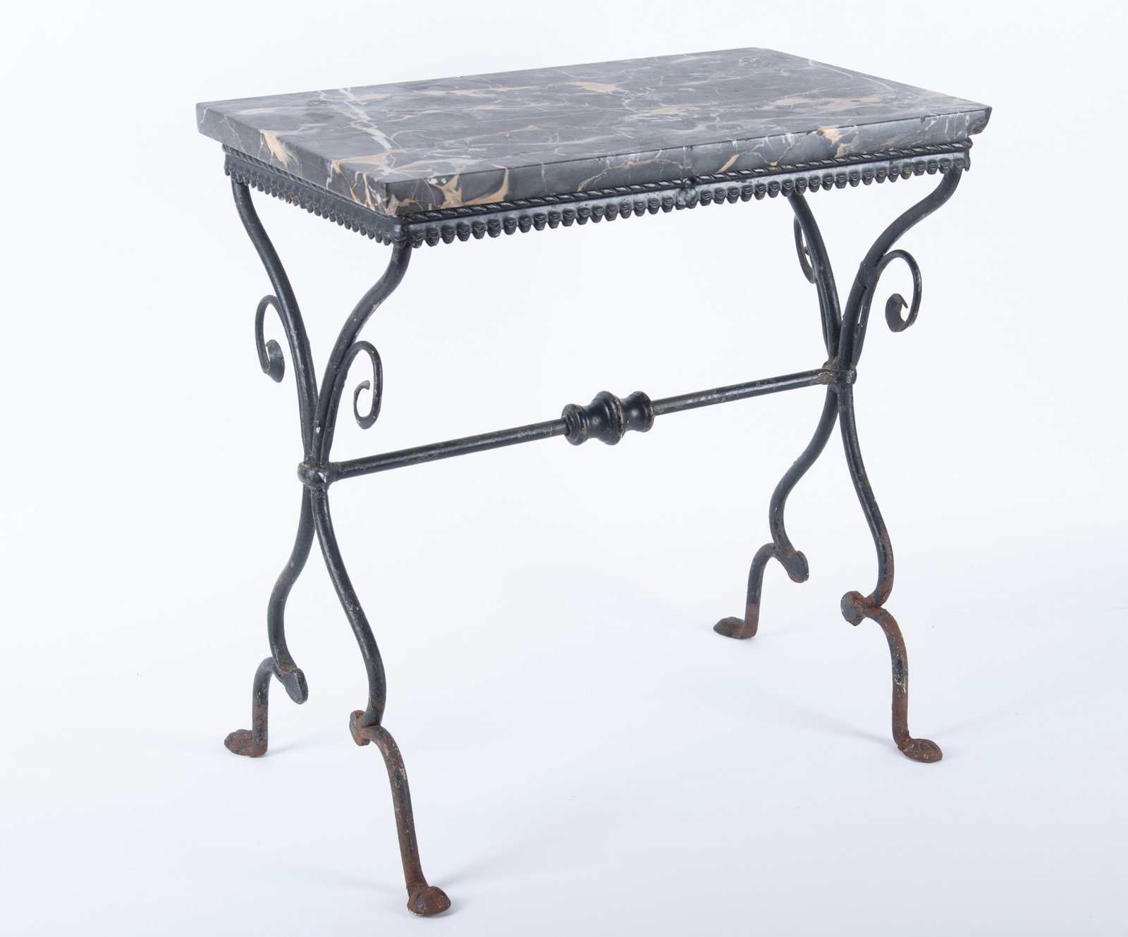 Early 1920's French Art Deco Iron Table: Early 1920's French Art Deco Iron Table Art Deco design, wrought iron table featuring a black marble top supported by an ornate wrought iron base. The design element includes a scalloped edge of a "pi