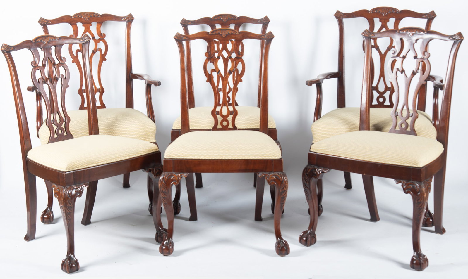Set Of Six Twentieth Century Chippendale Style Dining Chairs: Set Of Six Twentieth Century Chippendale Style Dining Chairs Serpentine head rail with acanthus leaves above a pierced back splat above padded gold seats resting on cabriole legs with foliate designs 