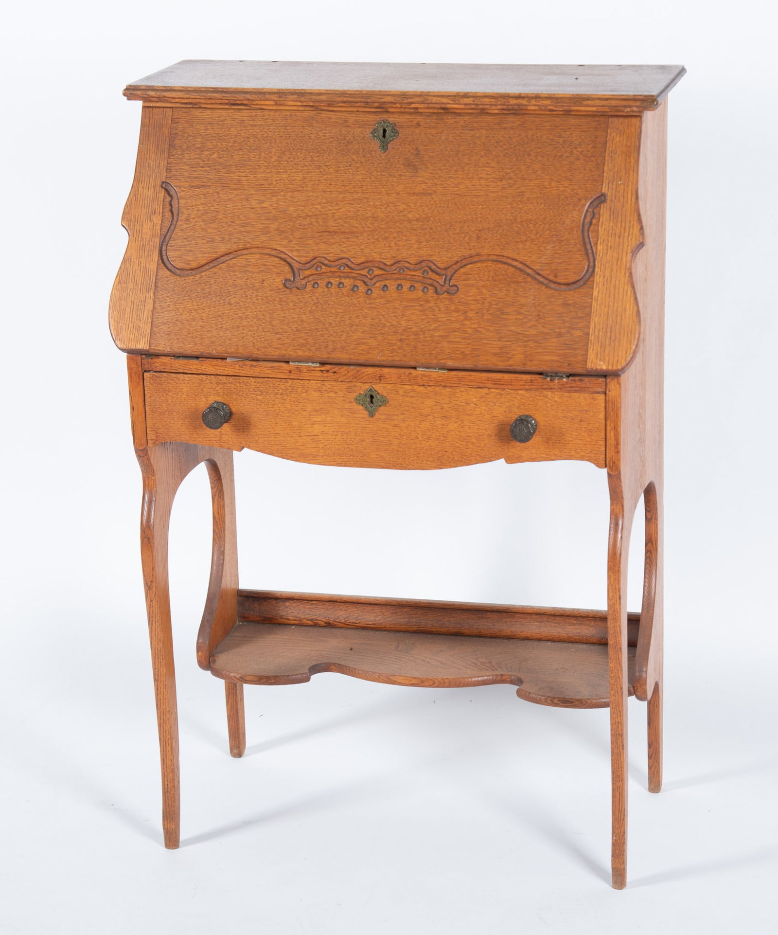 Antique American Slant Front Writing Desk: Antique American Slant Front Writing Desk Slant front desk with carved detail. Brass finishes. Inside pigeons holes and a small drawer. With key 41 x 27 1/2 x 15 inches