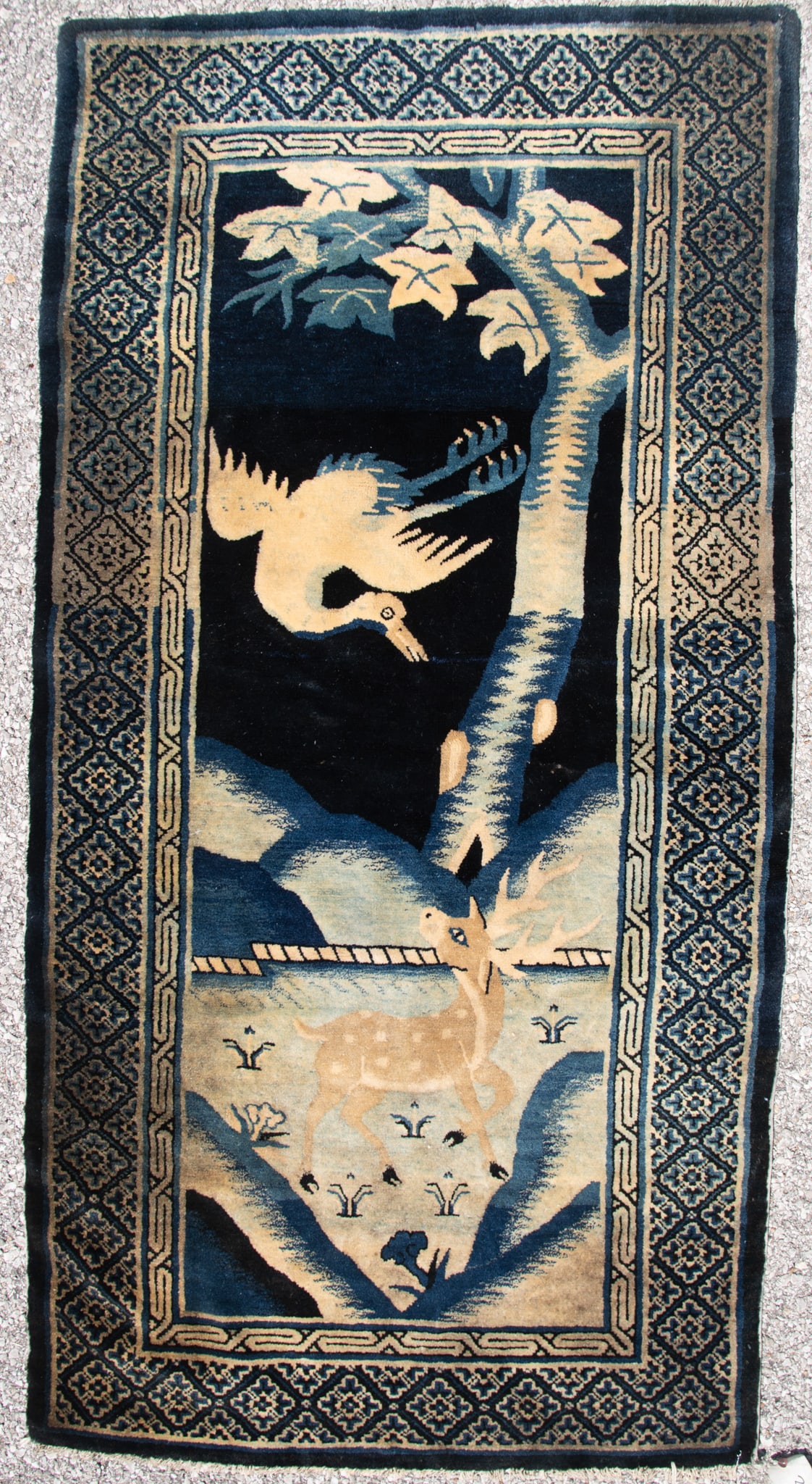 Handwoven Chinese Area Rug: Handwoven Chinese Area Rug The blue field having a landscape with tree and stylized Phoenix bird in flight above a buck all centering a a geometric border. 3' x 5' 9"