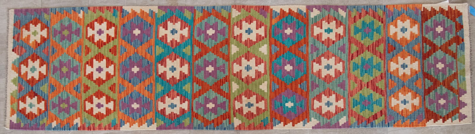 Handwoven Kilim Runner: Handwoven Kilim Runner Multiple bands of vibrant colors and shaped patterns in red, green, blue orange and green. 2' 8" x 9' 7"