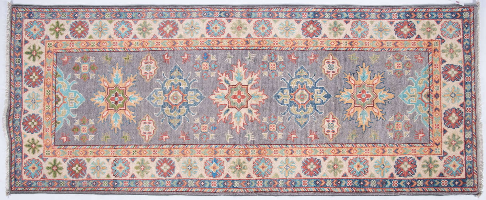 Handwoven Kazak Runner: Handwoven Kazak Runner Muted blue field having seven stylized medallions in blue, red and cream centering a floral primary border and guard borders. 2' 6" x 6' 4"