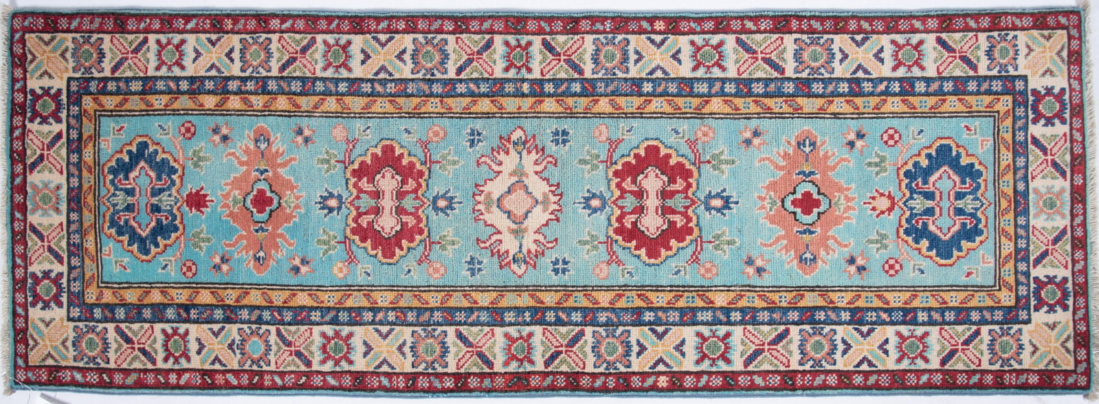 Handwoven Kazak Runner: Handwoven Kazak Runner Light blue field with seven shaped medallions in alternating shades in blue, red, green and cream centering multiple 2' 1" x 6'
