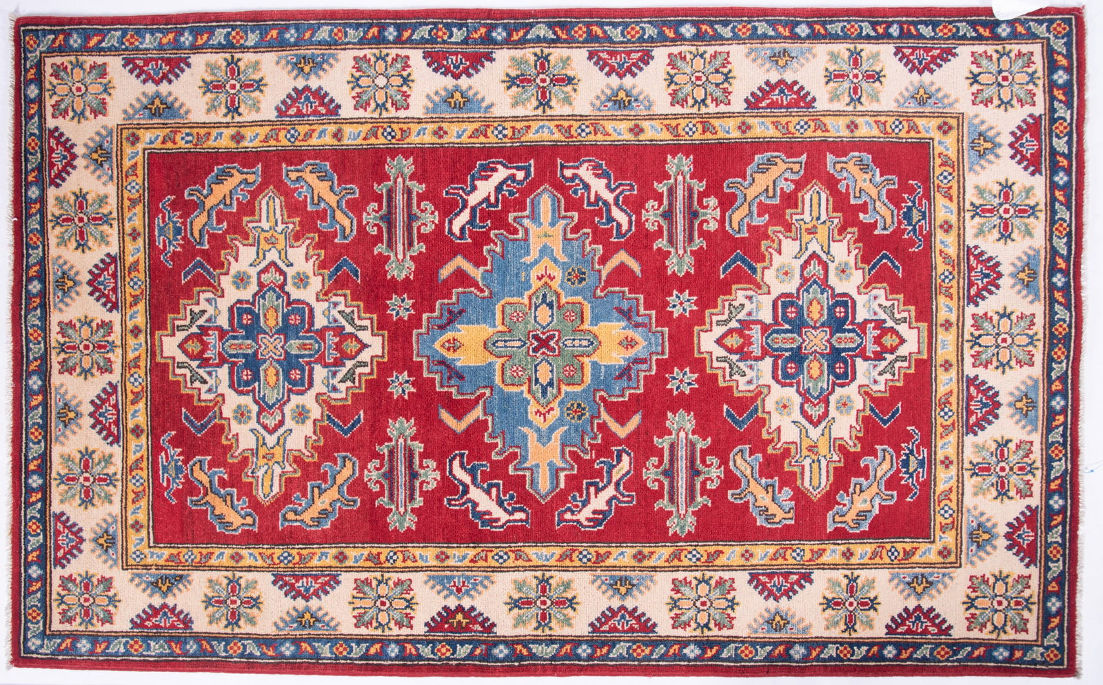 Handwoven Kazak Runner: Handwoven Kazak Runner Deep red field with blue lobed medallion centering a pair of medallions in shades of ivory, blue, red and green with a wide floral filled primary border and a pair of guard