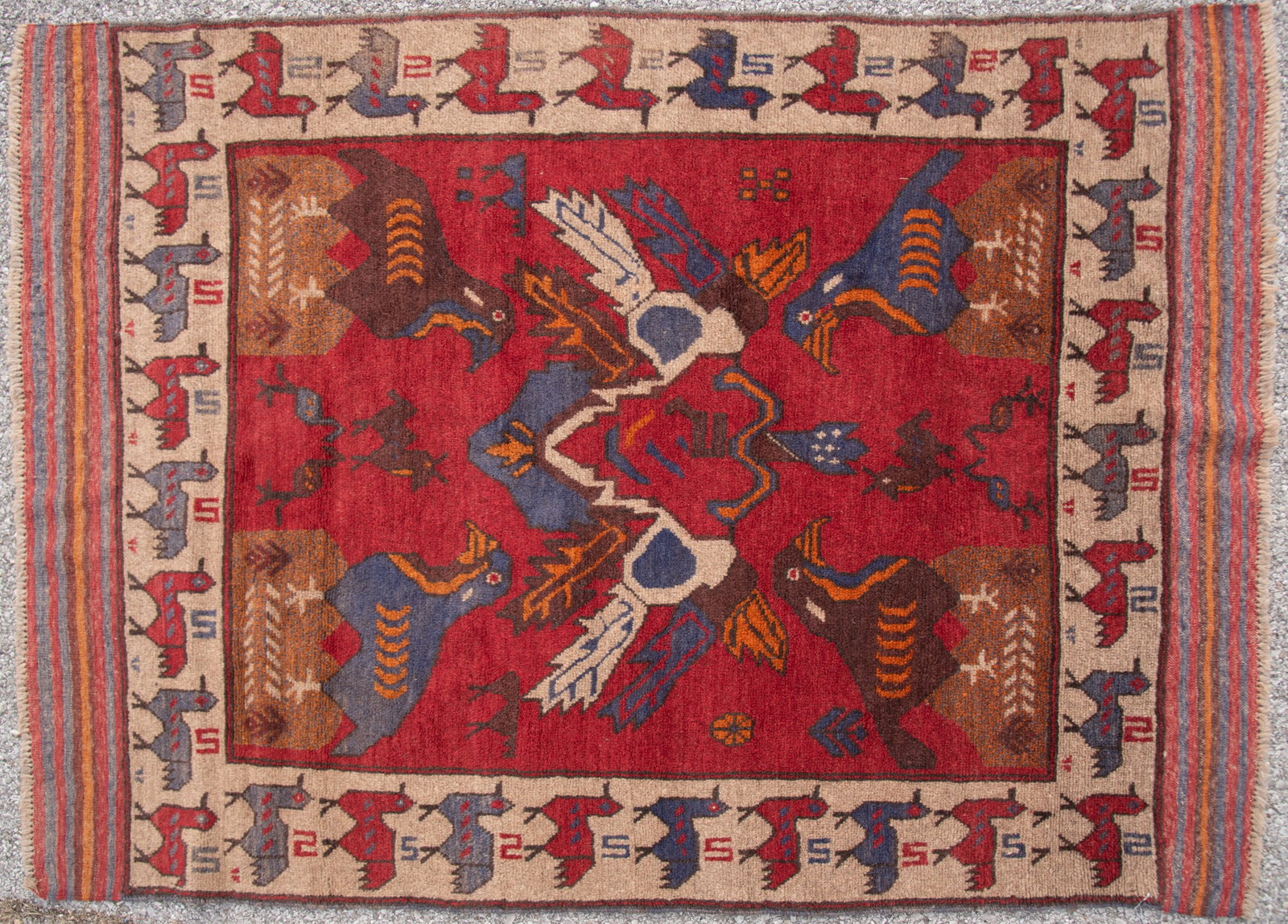 Handwoven Afghani Throw Rug: Handwoven Afghani Throw Rug All over animal designs in red, blue, tan and white centering a camel figural primary border 4' x 5'