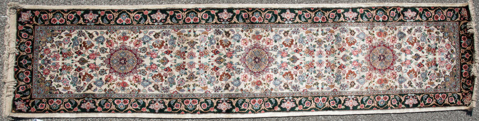 Handwoven Persian Runner: Handwoven Persian Runner Three shaped and circular medallions on an ivory floral filled field centering a dark green floral border and a pair of guard borders. 2' 8" x 10'