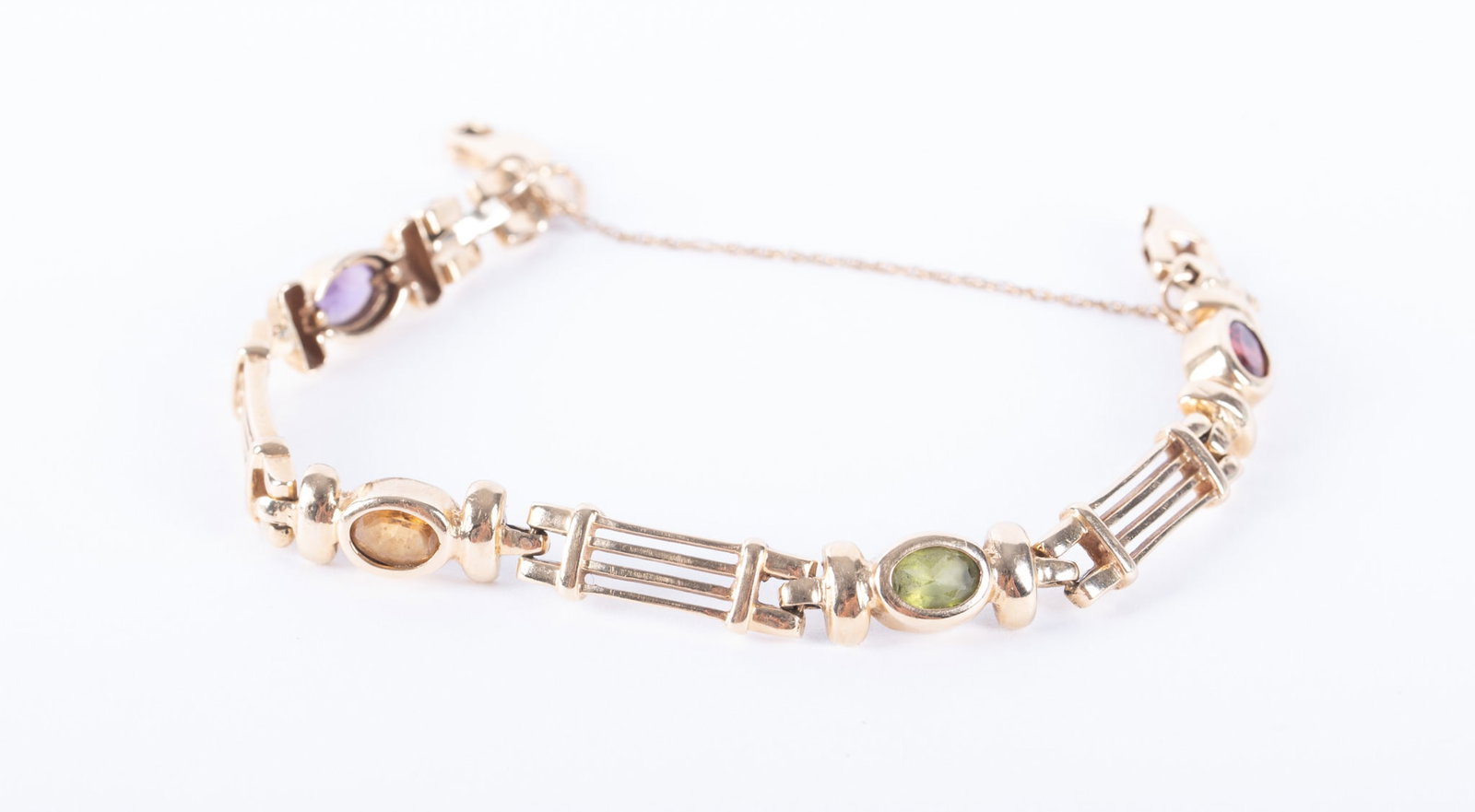 14K Yellow Gold Multi Stone Link Bracelet: 14K Yellow Gold Multi Stone Link Bracelet The oval faceted stones in this bracelet are garnet, amethyst, peridot and citrine. The length is 7 inches and the weight is 15.9g including stones.