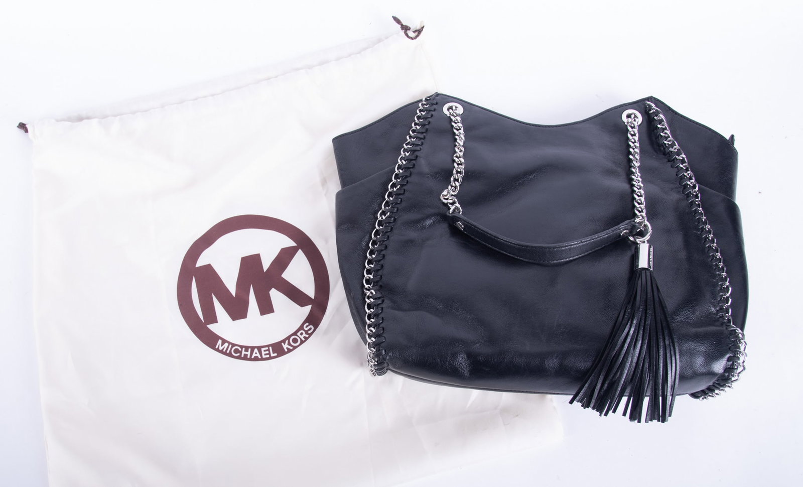 Large Vintage Michael Kors Black Leather Tote Bag: Large Vintage Michael Kors Black Leather Tote Bag like new condition with chain and leather handle, black leather tassel hanging from handle; chain strung along side perimeter of bag; size 13 x 12 x 7