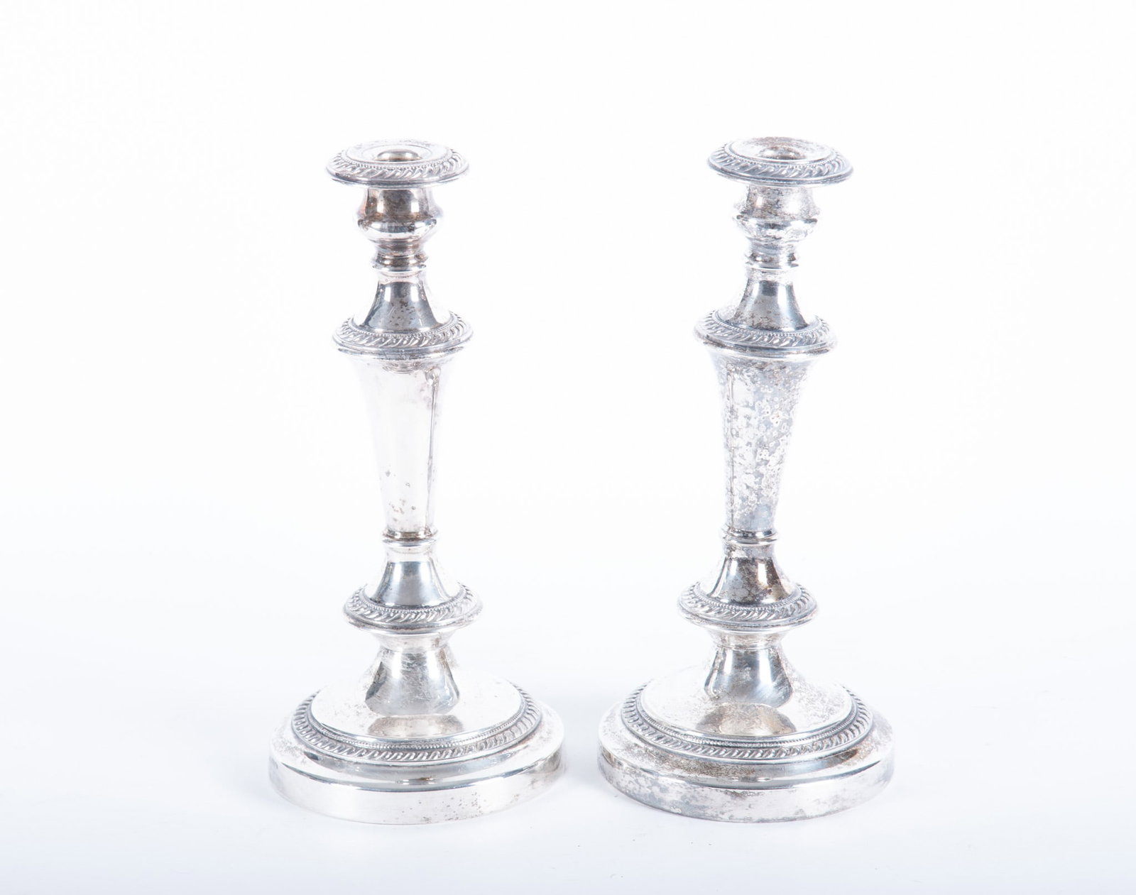 A Large Pair of Sheffield Style Plated Silver Candlesticks: A Large Pair of Sheffield Style Plated Silver Candlesticks England, an oversize pair of silver plated sticks with gadroon borders. 12 1/2 inches tall; 5 3/4 inch diameter base.