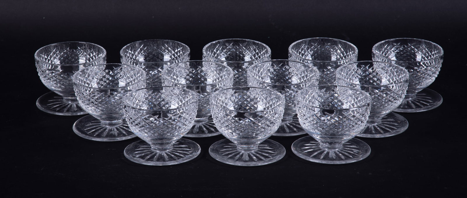 Twelve Waterford Alana Pattern Footed Desert Bowls: Twelve Waterford Alana Pattern Footed Desert Bowls Ireland, 12 vintage Waterford cut-foot desert bowls featuring distinctive deep, narrow vertical cuts combined with wide, diamond hatch pattern. 3 x