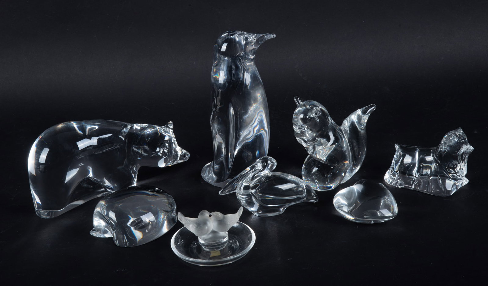 A Large Collection of Crystal Animals and Table Articles: A Large Collection of Crystal Animals and Table Articles The lot includes a Lalique ring dish, a large Daum penguin, an unusual Baccarat half apple, Baccarat dog, Baccarat pelican, Baccarat heart, an