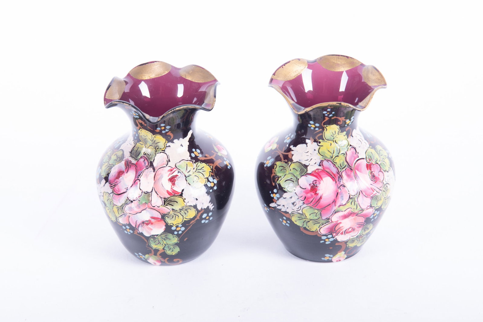 A Pair of Antique English Enameled Amethyst Glass Cabinet Vases: A Pair of Antique English Enameled Amethyst Glass Cabinet Vases England, the Victorian era cabinet vases having ruffled and gilded rims, the front of the amethyst vases enameled with roses. 3 1/4 x 4 