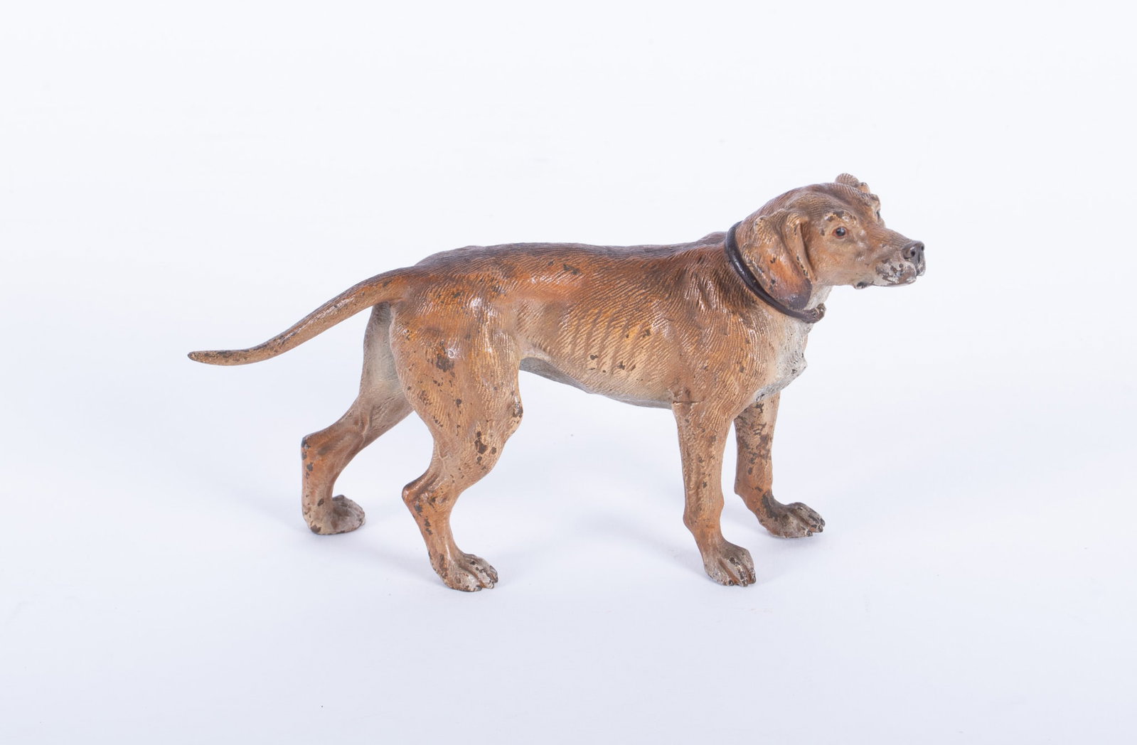 A Vienna Bronze Figure of a Chestnut Color Hunting Dog: A Vienna Bronze Figure of a Chestnut Color Hunting Dog Austria, early 20th century, a cold painted and finely detailed bronze of a hunting dog with extended tail. Apparently unmarked. 4 x 7 inches