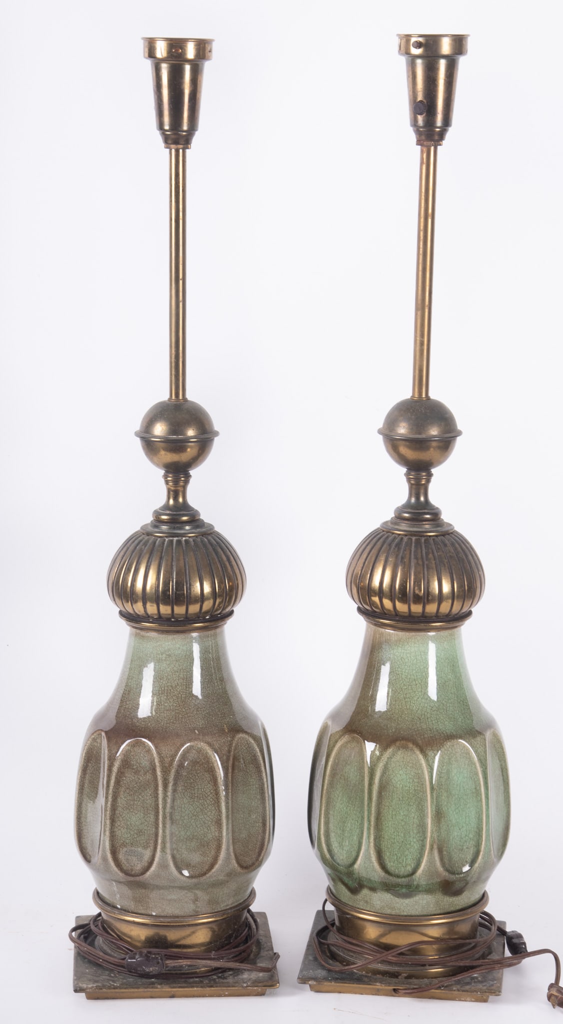 A Pair of Stiffel Pottery Table Lamps, Circa 1960s: A Pair of Stiffel Pottery Table Lamps, Circa 1960s Green crackle glaze with brass fitments, having partial Stiffel stickers on the sockets, white conical shades Height: 33 1/2 inches