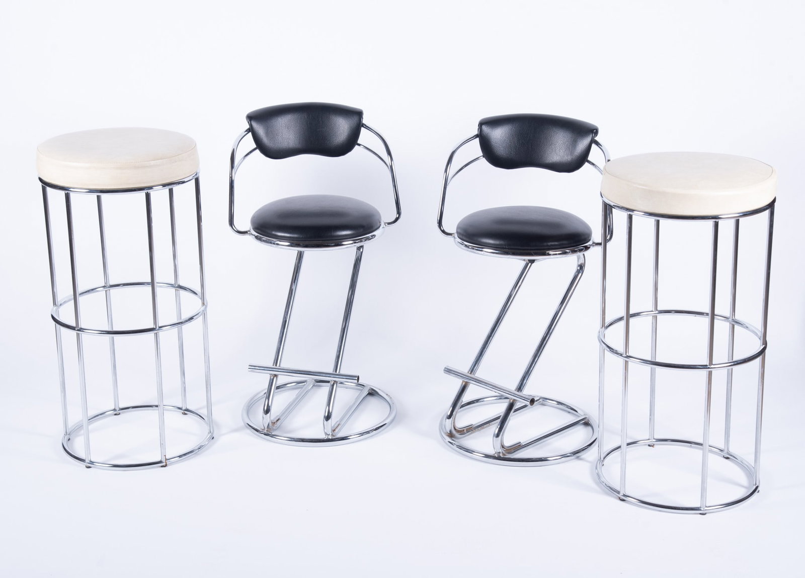 Two Pairs of Vintage MCM Barstools: Two Pairs of Vintage MCM Barstools Chrome frames with black and cream colored upholstery. Black: 32 x 16 1/2 inches; Cream: 31 x 15 inches