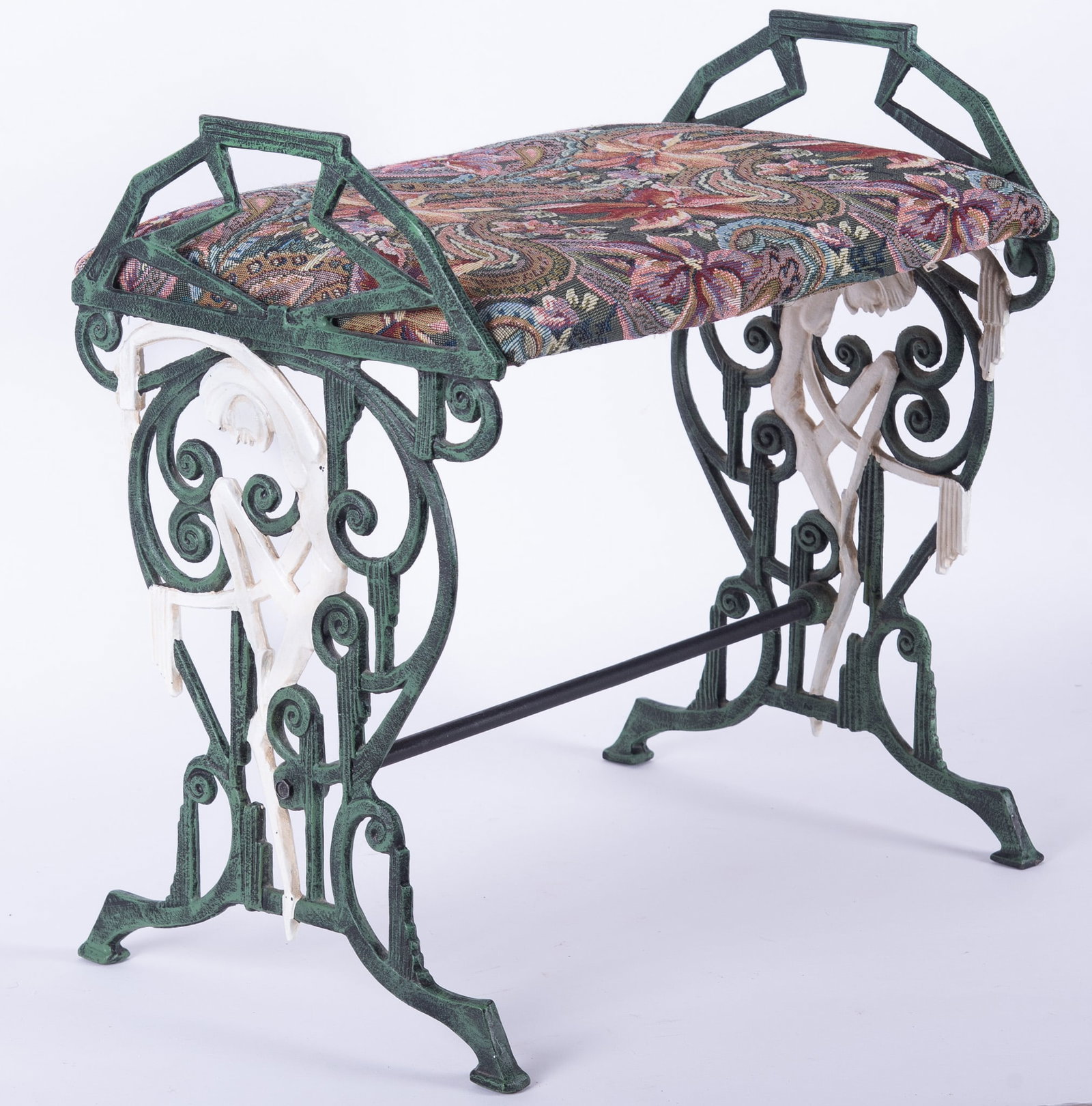 An Art Deco Cast Iron Stool: An Art Deco Cast Iron Stool The sides featuring green cast iron with white painted dancers, having a fine multi-colored paisley upholstery. 19" x 18.5" x 12.5"