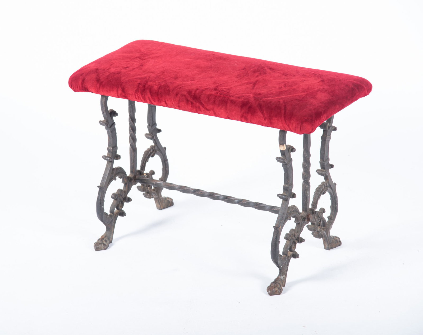 An Antique Victorian-Style Iron Bench: An Antique Victorian-Style Iron Bench Featuring ornate cast iron legs, having claw feet and a vibrant red velvet upholstery. 25 x 17 x 12