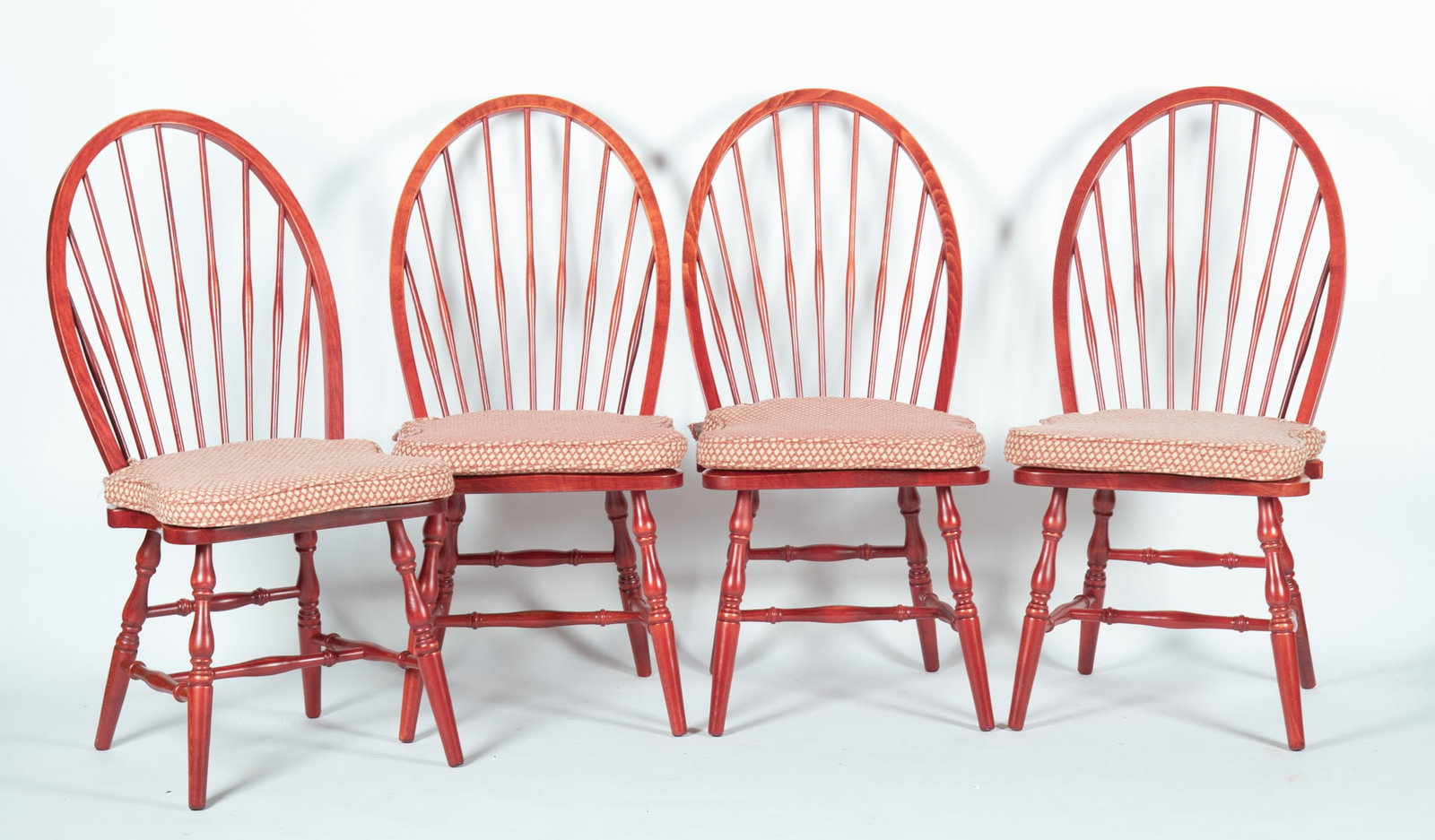 A Set of Ten Red Painted Windsor Design Dining Chairs: A Set of Ten Red Painted Windsor Design Dining Chairs with arched backs and ringed legs. 41 x 19 1/2 x 22 inches