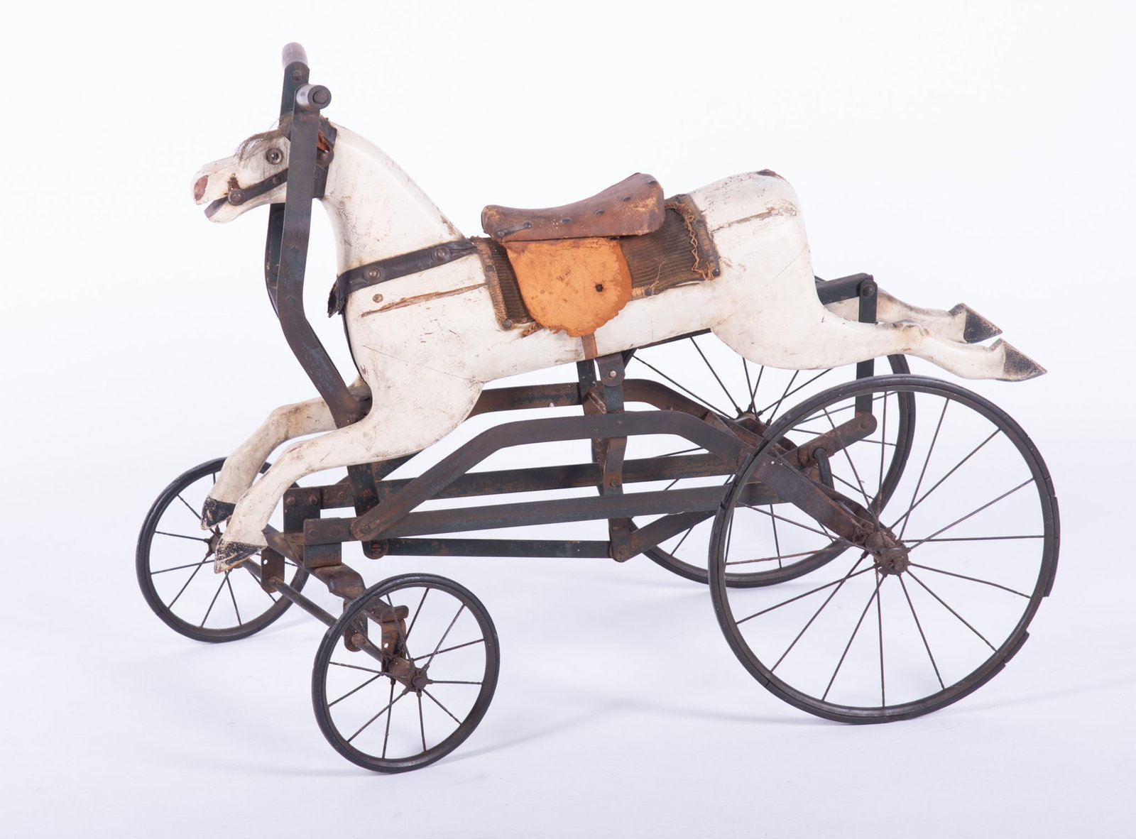 Early To Mid Nineteenth Century Horse Form Child's Toy: Early To Mid Nineteenth Century Horse Form Child's Toy White painted horse having four metal spoked wheels and steering mechanism. The forelock on the horse is authentic horse hair. 26 x 33 x 17 1/2